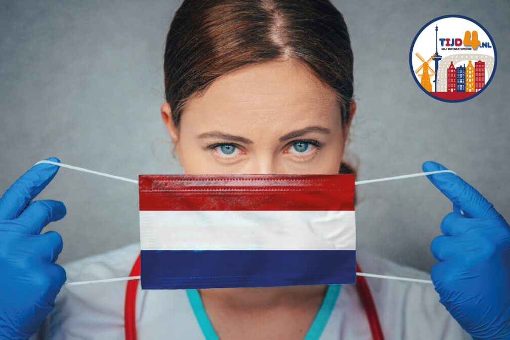 A doctor holding a face mask with the colors of the Dutch flag