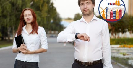 A Dutch woman and a man keep time by looking at their watches