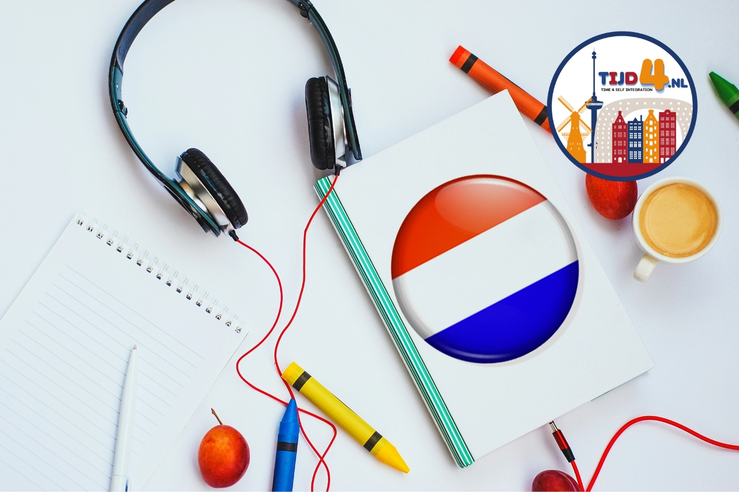 A notebook with the Dutch flag, a desk with headphones and pens